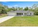 Charming one-story home features a two-car garage and well-maintained lawn, enhancing its curb appeal at 9835 Sw 207Th Cir, Dunnellon, FL 34431