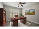 Cozy home office with wooden desk, shelving, and bright natural light at 9835 Sw 207Th Cir, Dunnellon, FL 34431