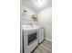 Laundry room complete with washer, dryer, shelving, and neutral paint at 9835 Sw 207Th Cir, Dunnellon, FL 34431