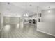 Expansive open-concept living area flows seamlessly into a modern kitchen with stainless steel appliances at 9835 Sw 207Th Cir, Dunnellon, FL 34431