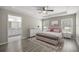 Elegant main bedroom with tray ceiling, stylish furnishings, and an ensuite bathroom at 9835 Sw 207Th Cir, Dunnellon, FL 34431