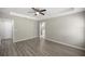 Open main bedroom features tray ceiling and attached bathroom with modern grey flooring at 9835 Sw 207Th Cir, Dunnellon, FL 34431