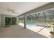 Screened patio with ceiling fan and views of the private pool and spa in backyard at 9835 Sw 207Th Cir, Dunnellon, FL 34431