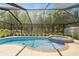 Inviting screened-in pool with attached hot tub and beautiful outdoor scenery at 9835 Sw 207Th Cir, Dunnellon, FL 34431
