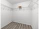 Walk-in closet with laminate flooring and metal shelving to maximize storage space at 9835 Sw 207Th Cir, Dunnellon, FL 34431