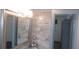 Bathroom featuring a framed mirror, modern tile, and decorative accents at 9880 Sw 101St Pl, Ocala, FL 34481