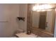 Charming bathroom featuring a modern vanity, tiled accent wall, and brushed nickel fixtures at 9880 Sw 101St Pl, Ocala, FL 34481