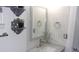 Bathroom vanity with a marble countertop, modern faucet, and decorative shelves, creating an elegant space at 9880 Sw 101St Pl, Ocala, FL 34481
