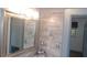 Bathroom featuring a framed mirror, modern tile, and decorative accents at 9880 Sw 101St Pl, Ocala, FL 34481