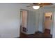 Spacious bedroom featuring wood floors, ceiling fan, and neutral paint, leading to closet space at 9880 Sw 101St Pl, Ocala, FL 34481