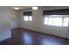 Bright bedroom featuring wood flooring, natural light, and neutral paint at 9880 Sw 101St Pl, Ocala, FL 34481