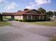 Exterior view of a clubhouse with a brick facade, covered entrance, and well-maintained landscaping at 9880 Sw 101St Pl, Ocala, FL 34481