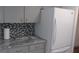 Kitchen featuring gray cabinets, granite countertops, and stainless steel refrigerator at 9880 Sw 101St Pl, Ocala, FL 34481