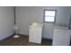 Convenient laundry room with washer, dryer, fan, and a window for natural light at 9880 Sw 101St Pl, Ocala, FL 34481