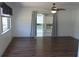 Bright living room featuring wood flooring, sliding doors to a lanai, and a ceiling fan at 9880 Sw 101St Pl, Ocala, FL 34481