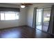 Bright living room featuring wood flooring, a ceiling fan, and sliding doors to the lanai at 9880 Sw 101St Pl, Ocala, FL 34481