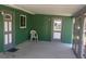 Covered patio featuring two doors, a chair, and neutral colors at 9880 Sw 101St Pl, Ocala, FL 34481