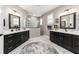 Bathroom featuring double sink vanities and a walk-in shower with glass surround at 10082 Sw 82Nd Place Rd, Ocala, FL 34481