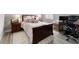 Comfortable bedroom featuring hardwood furniture, a plush bed with decorative pillows, and lots of natural light at 10082 Sw 82Nd Place Rd, Ocala, FL 34481