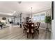 Dining room connected to the living room with wood-look floors and natural light from the windows at 10082 Sw 82Nd Place Rd, Ocala, FL 34481