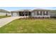 Beautiful single-story home with lush lawn, brick driveway, two-car garage, and meticulously landscaped yard at 10082 Sw 82Nd Place Rd, Ocala, FL 34481