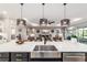 Spacious kitchen island with stainless steel sink and seating overlooking the living area at 10082 Sw 82Nd Place Rd, Ocala, FL 34481