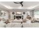 Spacious living room with elegant furnishings, contemporary decor, and tray ceiling with fan at 10082 Sw 82Nd Place Rd, Ocala, FL 34481