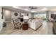 Bright living room featuring modern decor, wood-look flooring, and a sliding glass door to the outdoor space at 10082 Sw 82Nd Place Rd, Ocala, FL 34481