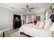 Bright main bedroom with a tray ceiling, wood-look floors, and a large bed at 10082 Sw 82Nd Place Rd, Ocala, FL 34481