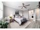 Beautiful main bedroom with grey color palette, a ceiling fan, a plush bed, and stylish decorations at 10082 Sw 82Nd Place Rd, Ocala, FL 34481