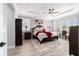 Bedroom features wood-look floors, tray ceiling, ceiling fan, and a decorative area rug at 10082 Sw 82Nd Place Rd, Ocala, FL 34481
