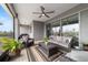 Spacious screened patio with modern furniture, a ceiling fan, and an outdoor grill area for entertaining at 10082 Sw 82Nd Place Rd, Ocala, FL 34481