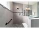 This shower features gray tile, a frameless glass enclosure, black fixtures, and a built-in niche at 10082 Sw 82Nd Place Rd, Ocala, FL 34481