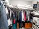 Spacious walk-in closet with overhead shelving, hanging storage and wood flooring at 10082 Sw 82Nd Place Rd, Ocala, FL 34481