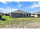 A well-maintained backyard with a view of the home's exterior and manicured landscaping at 10327 Sw 96Th Loop, Ocala, FL 34481