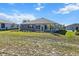 A sprawling backyard with lush green grass, complemented by the home's neutral exterior at 10327 Sw 96Th Loop, Ocala, FL 34481