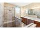 Bathroom featuring a glass-enclosed shower with built-in bench, and double sink vanity at 10327 Sw 96Th Loop, Ocala, FL 34481