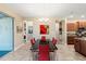 Spacious dining room with modern table set, leading to the kitchen and an outdoor living area at 10327 Sw 96Th Loop, Ocala, FL 34481