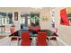 Elegant dining room featuring a modern table set with red chairs, with access to the outdoor living space at 10327 Sw 96Th Loop, Ocala, FL 34481