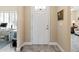 Bright entryway featuring neutral tones, tile flooring, and an adjacent office space at 10327 Sw 96Th Loop, Ocala, FL 34481