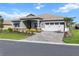 Beautifully landscaped home with a stone-accented facade and a spacious two-car garage at 10327 Sw 96Th Loop, Ocala, FL 34481