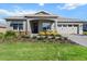Lovely one-story home with manicured lawn, flowering shrubs, and a two-car garage at 10327 Sw 96Th Loop, Ocala, FL 34481