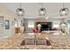 Bright open kitchen with granite countertops, stainless sink, and pendant lighting overlooking the living area at 10327 Sw 96Th Loop, Ocala, FL 34481