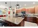 Modern kitchen featuring an island with granite countertops and dark wood cabinets with stainless steel appliances at 10327 Sw 96Th Loop, Ocala, FL 34481