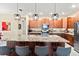 Well-lit open kitchen featuring a spacious granite island and dark wood cabinets at 10327 Sw 96Th Loop, Ocala, FL 34481