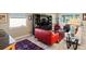 Well-lit living room featuring ample seating around a glass coffee table and dark entertainment center at 10327 Sw 96Th Loop, Ocala, FL 34481