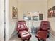 Sitting Area with two red leather chairs, artwork, lamp and carpeted flooring at 10327 Sw 96Th Loop, Ocala, FL 34481