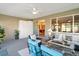 Relaxing sunroom featuring comfortable seating, a ceiling fan, and sliding glass doors to the backyard at 10327 Sw 96Th Loop, Ocala, FL 34481