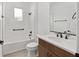 A bathroom with a white vanity, tiled shower/bath combination, and black fixtures at 10347 Sw 99Th Ln, Ocala, FL 34481