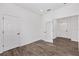 An empty bedroom with wood-look floors, white walls and two doors at 10347 Sw 99Th Ln, Ocala, FL 34481